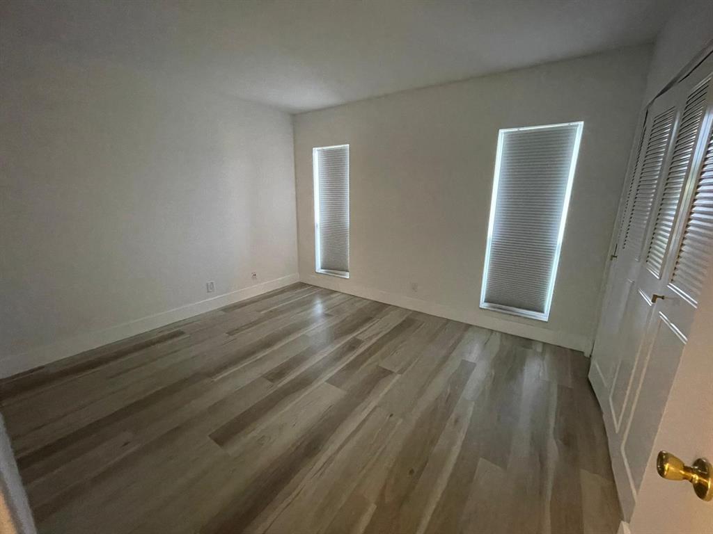 250 Northeast 20th Street, Unit 210 Boca Raton, FL 33431 - Photo 26 of 50 a view of an empty room with wooden floor and a window