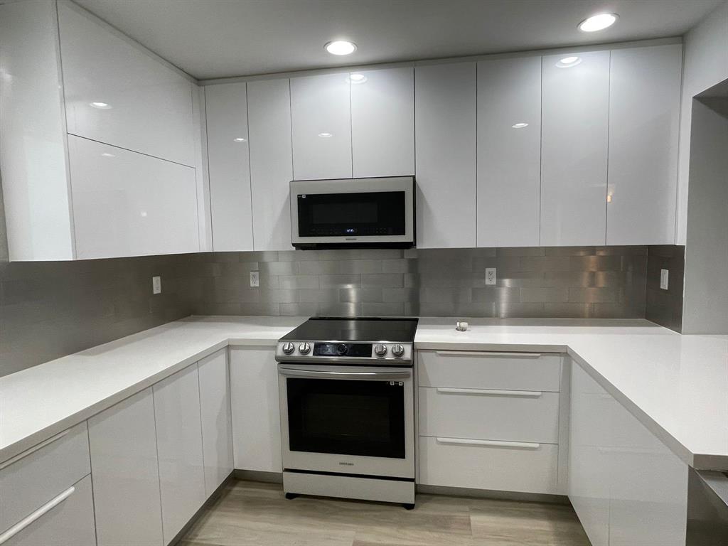 250 Northeast 20th Street, Unit 210 Boca Raton, FL 33431 - Photo 3 of 50 a kitchen with a stove and a microwave