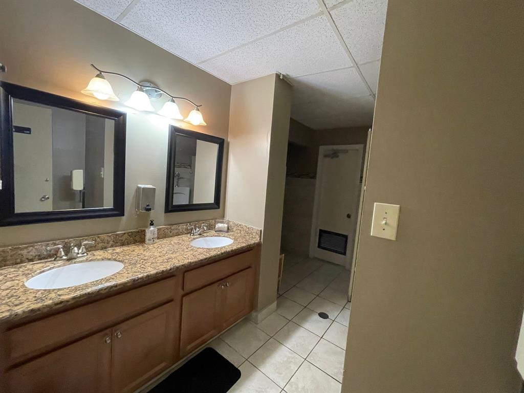 250 Northeast 20th Street, Unit 210 Boca Raton, FL 33431 - Photo 43 of 50 a bathroom with a granite countertop sink and a mirror