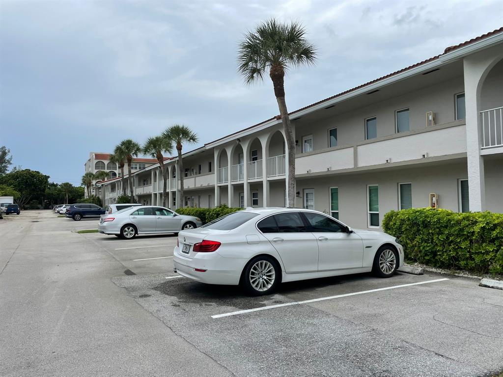 250 Northeast 20th Street, Unit 210 Boca Raton, FL 33431 - Photo 49 of 50 a car parked in front of a building