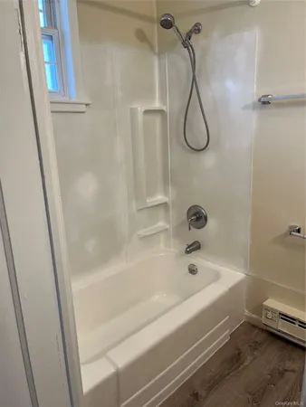 a bathroom with a bath tub with a shower