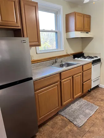 a kitchen with stainless steel appliances granite countertop a refrigerator sink and cabinets