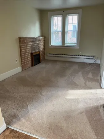an empty room with fireplace