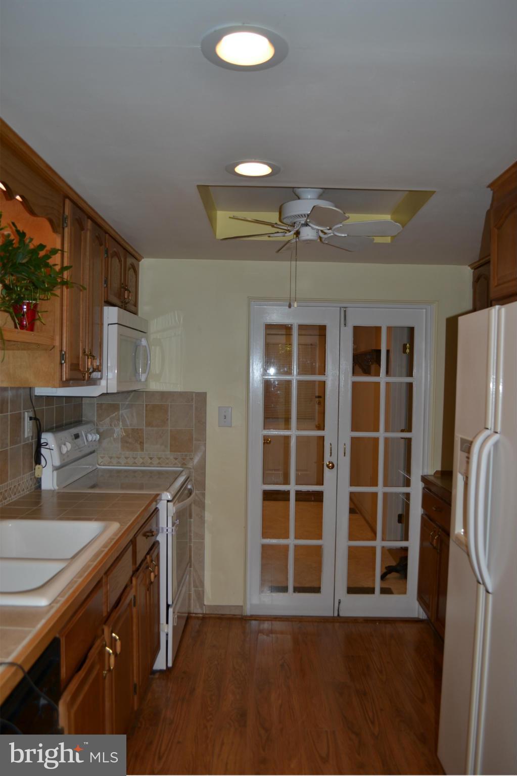 8046 Telegraph Road Severn, MD 21144 - Photo 8 of 27 a kitchen with a sink and a refrigerator