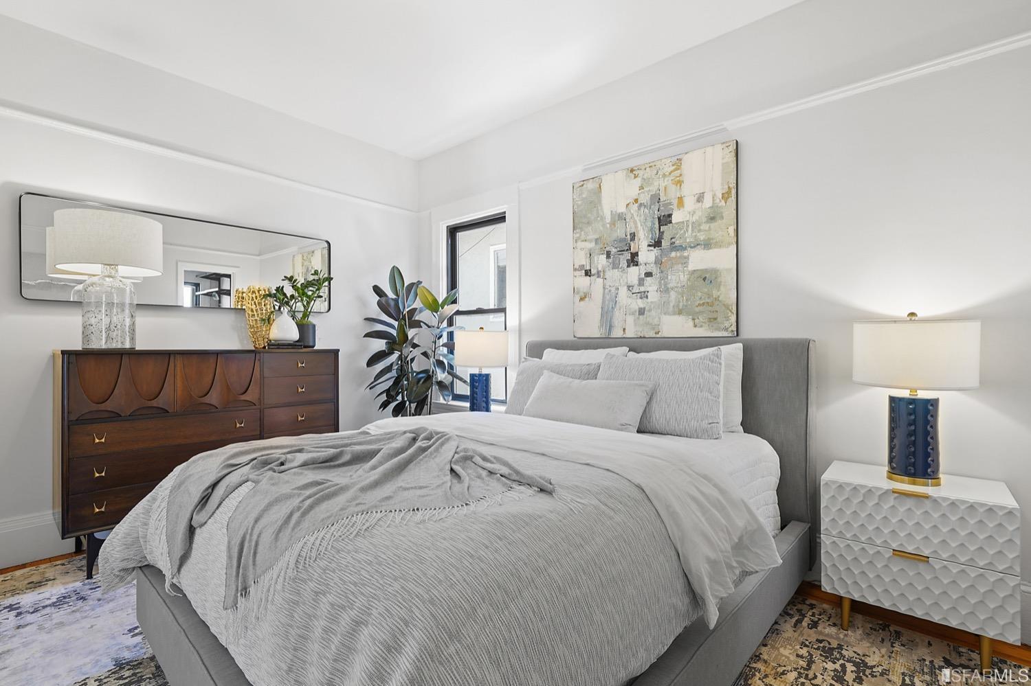 1015 26th Street Oakland, CA 94607 - Photo 13 of 33 a bedroom with a large bed and a painting on the wall