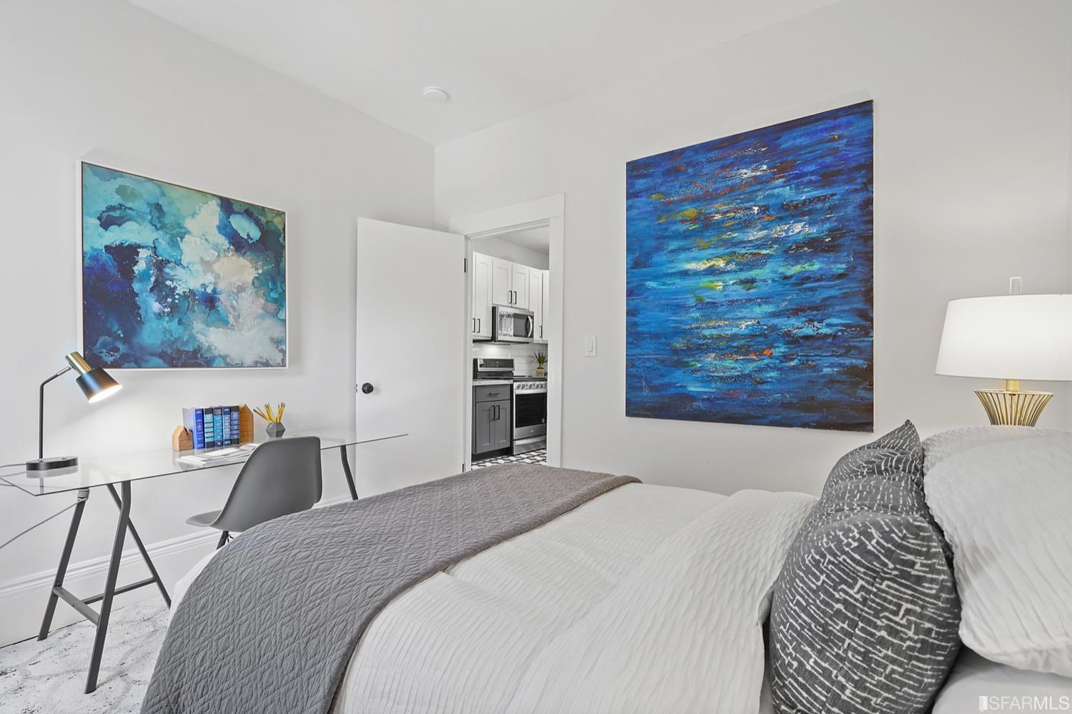 1015 26th Street Oakland, CA 94607 - Photo 17 of 33 a bedroom with a bed and a painting on the wall