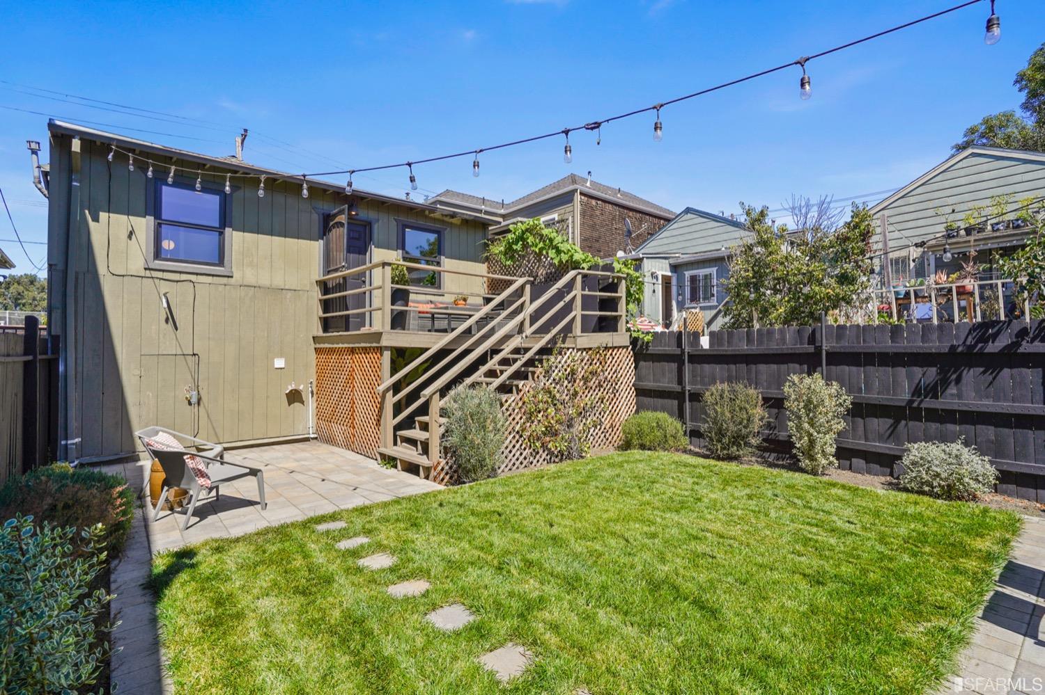 1015 26th Street Oakland, CA 94607 - Photo 28 of 33 a view of a house with a small yard and wooden fence