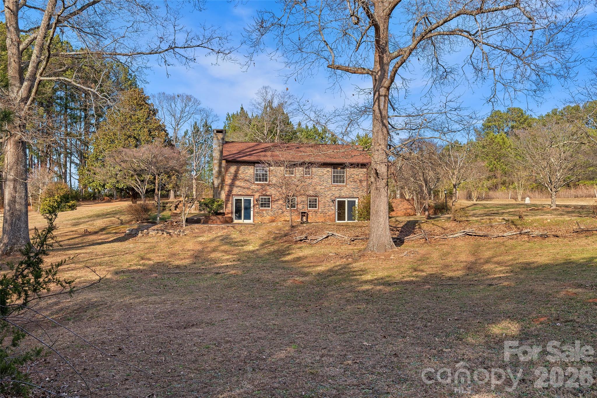 591 Landrum Road Tryon, NC 28782 - Photo 44 of 48 a view of a house with a yard covered with snow in the background
