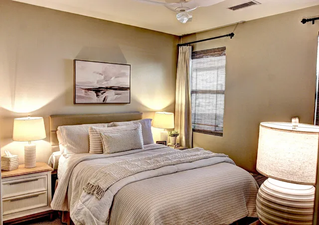 a bedroom with a bed and a painting on the wall