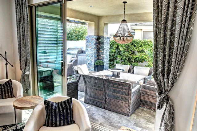 a living room with furniture a window and a table