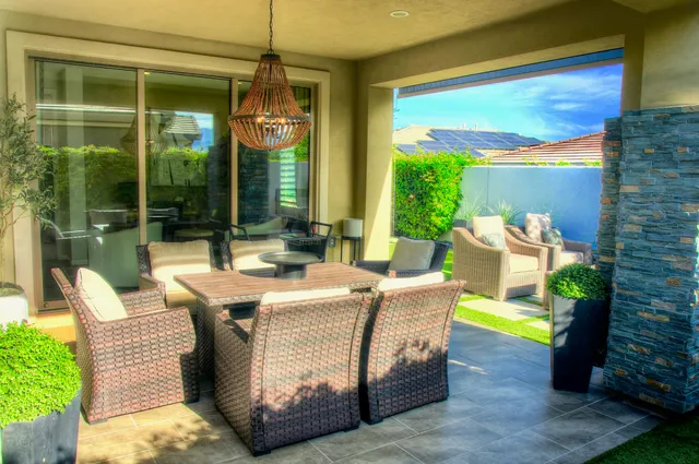 a view of an outdoor dining space with a table and chairs