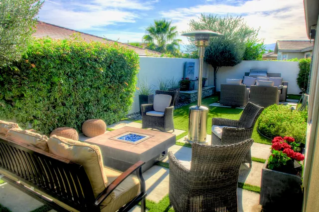a view of a patio that has couches chairs and a potted plant