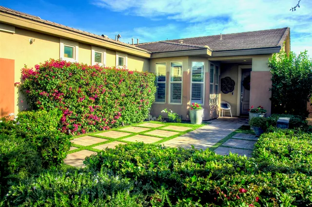 a front view of a house with garden