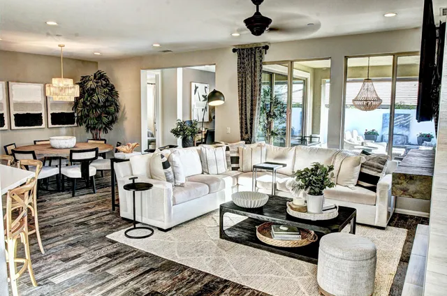 a living room with fireplace furniture and a large window