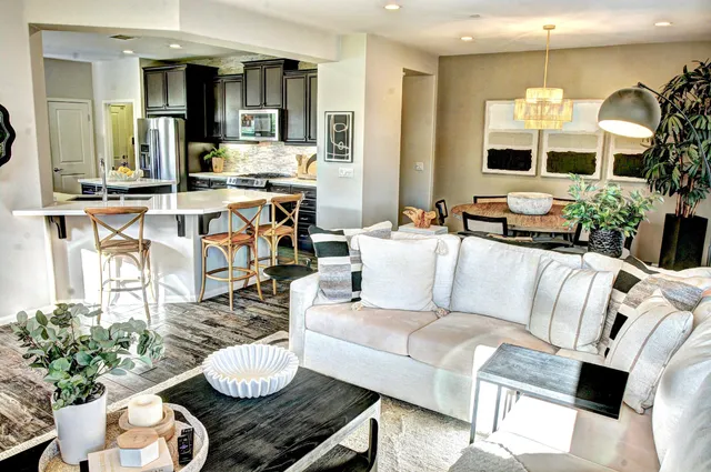 a living room with furniture and a large mirror