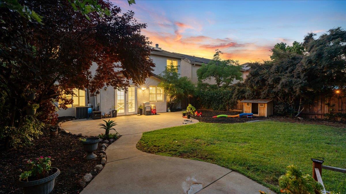 a view of a house with backyard and sitting area