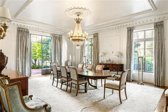 a kitchen with stainless steel appliances granite countertop a stove a sink dishwasher a dining table and chairs with wooden floor