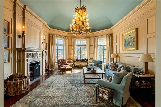 a living room with furniture and a floor to ceiling window