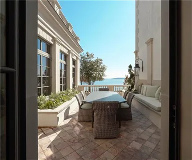 a living room with fireplace furniture and a large window