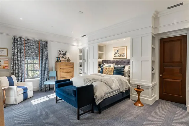 a bedroom with a bed and a large window