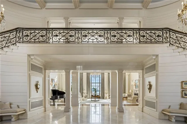a living room with patio furniture and a large window