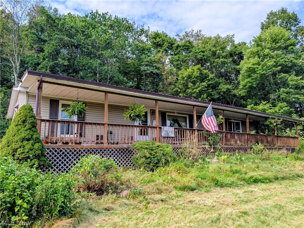 10811 Freedom Road Kimbolton, OH 43749 - Photo 1 of 38 Ranch Manufactured home with covered deck across the front and side