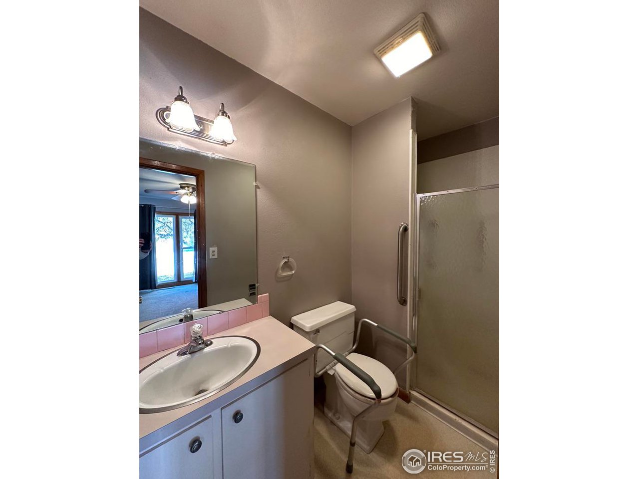 680 Clinic Drive Limon, CO 80828 - Photo 13 of 24 a bathroom with a granite countertop sink a toilet and a mirror