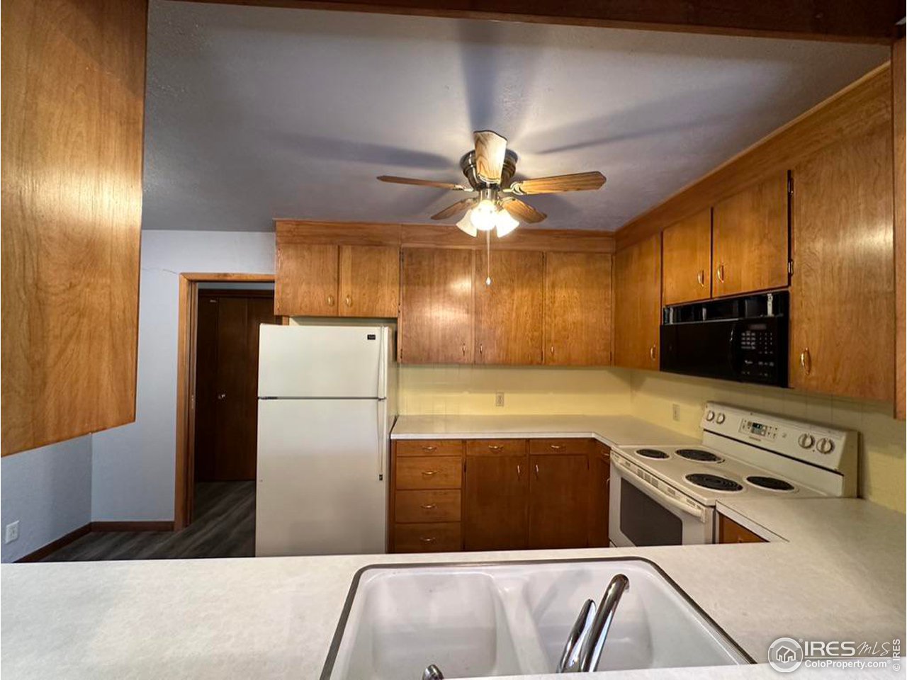 680 Clinic Drive Limon, CO 80828 - Photo 8 of 24 a kitchen with stainless steel appliances granite countertop a refrigerator a oven a sink with island and chairs