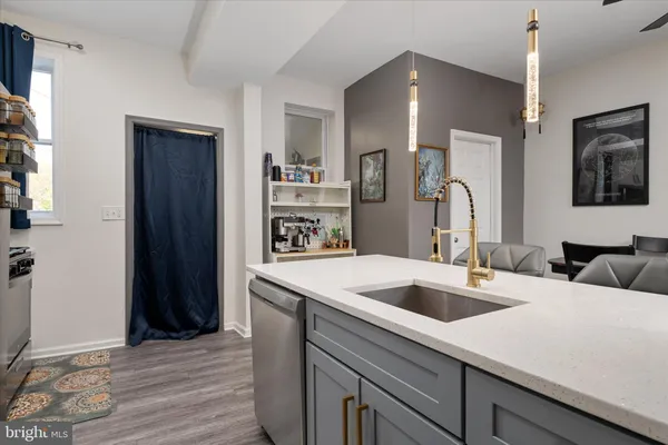 a kitchen with a sink a refrigerator and cabinets