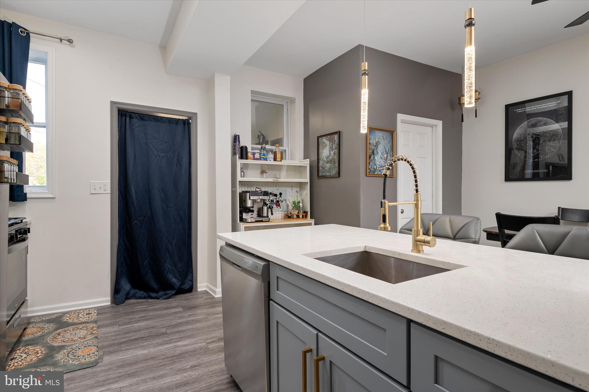 3714 5th Street Baltimore, MD 21225 - Photo 13 of 35 a kitchen with a sink a refrigerator and cabinets