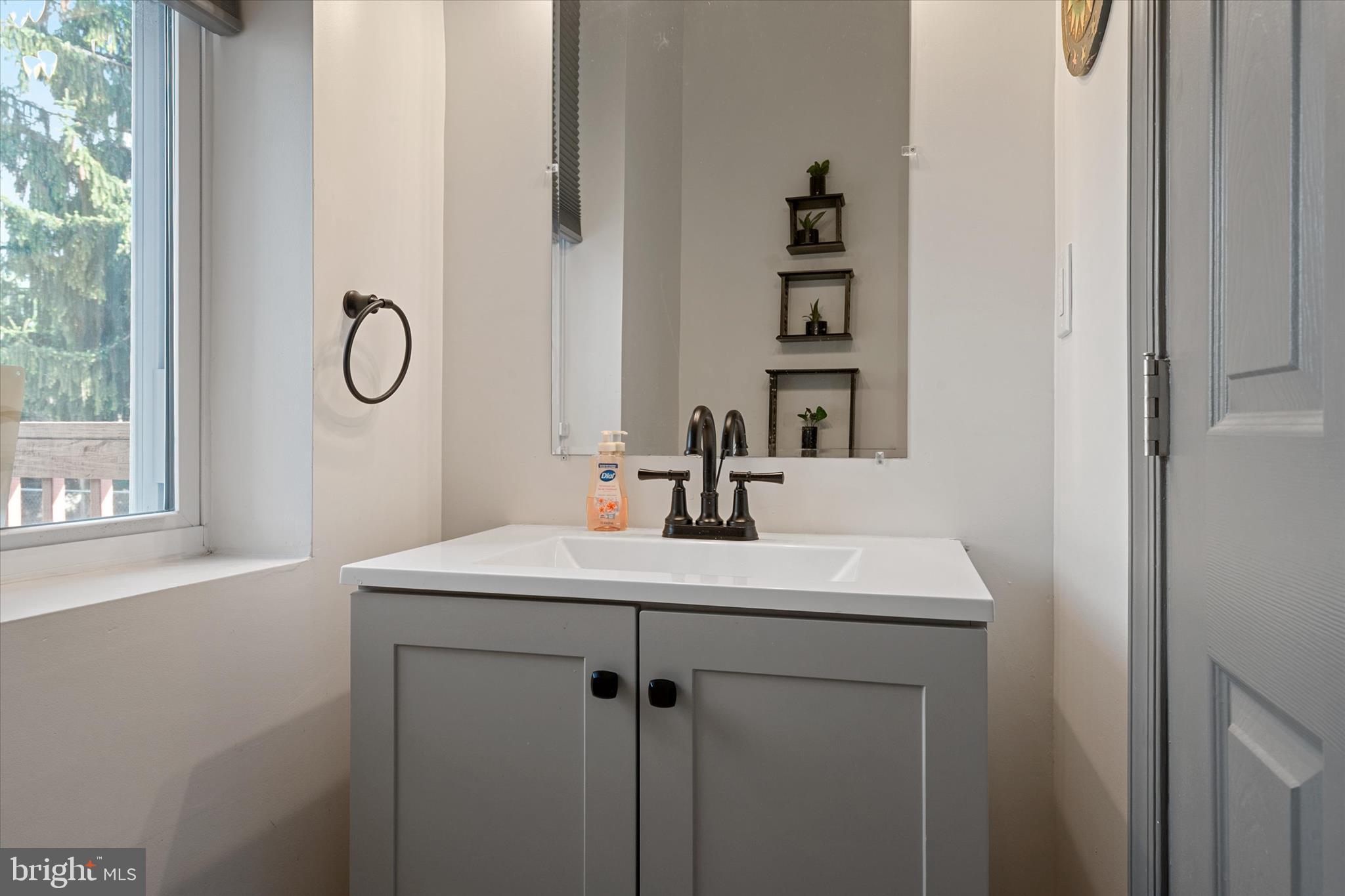 3714 5th Street Baltimore, MD 21225 - Photo 14 of 35 a bathroom with a sink vanity and a mirror