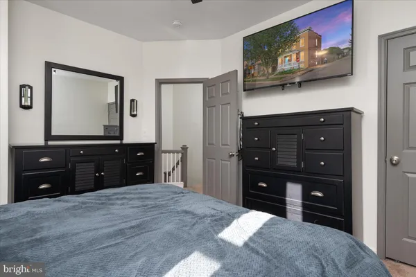 a room with a bed and a television