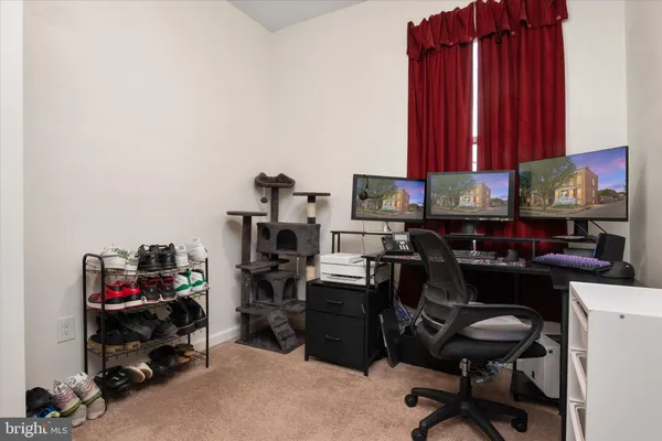 a view of a workspace with furniture and a gate