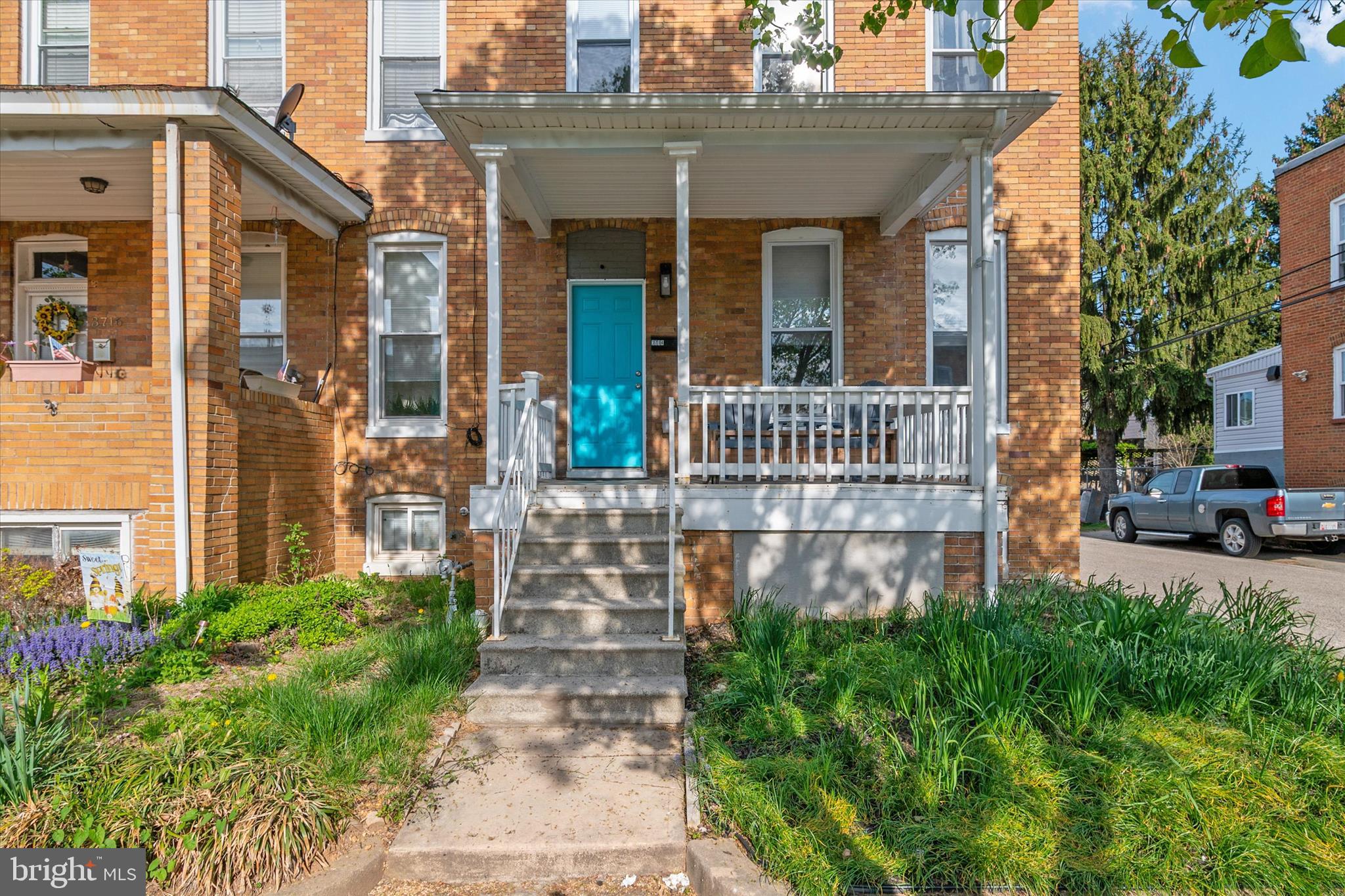 3714 5th Street Baltimore, MD 21225 - Photo 2 of 35 a view of a house with brick walls plants and large tree