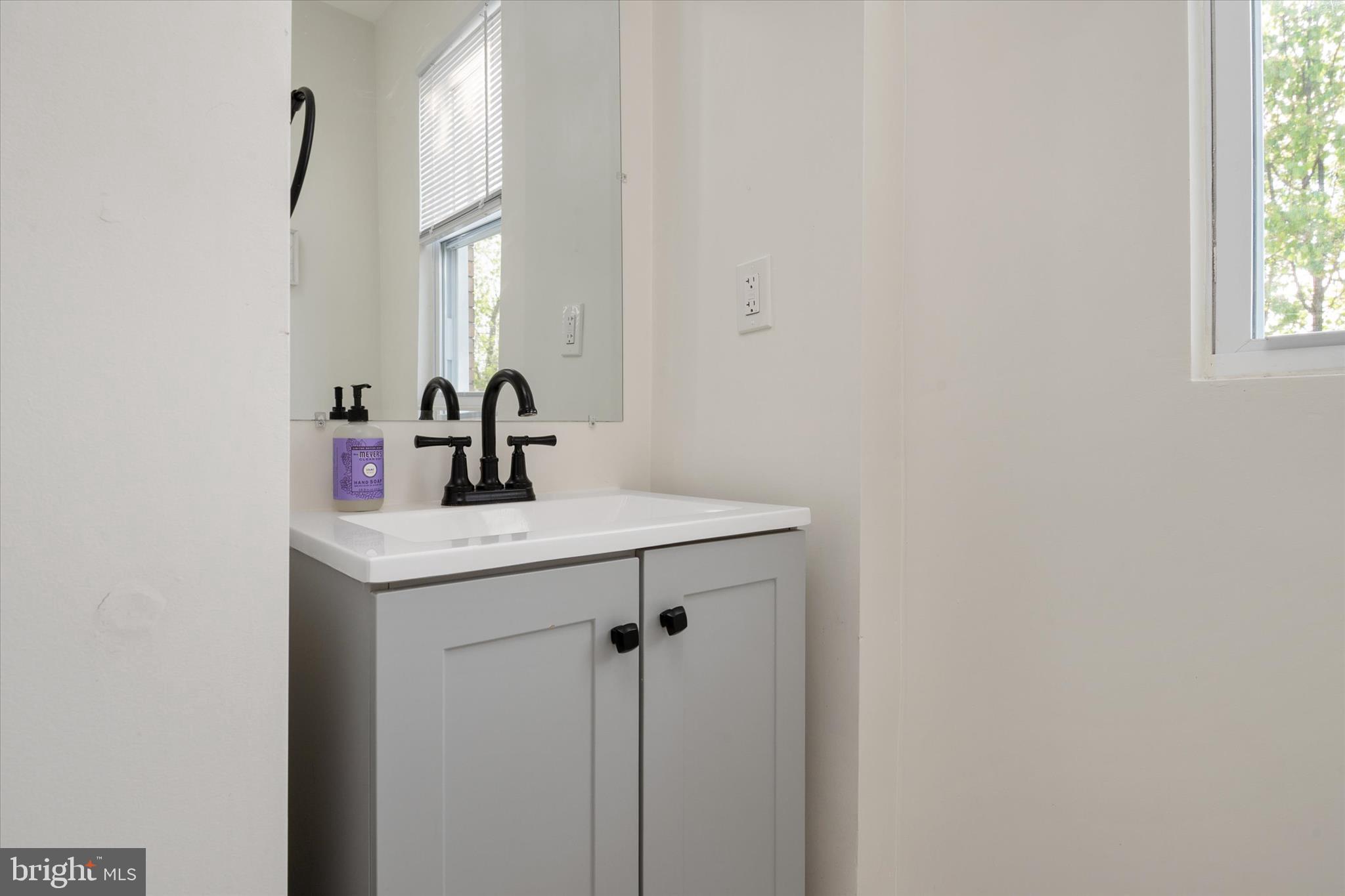 3714 5th Street Baltimore, MD 21225 - Photo 21 of 35 a bathroom with a sink and a mirror