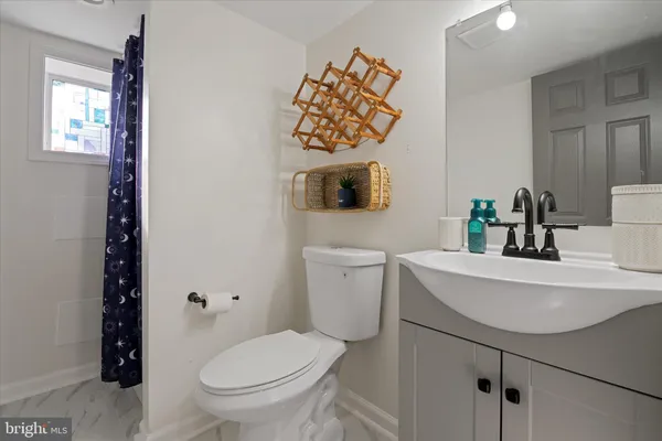 a bathroom with a sink a toilet and mirror