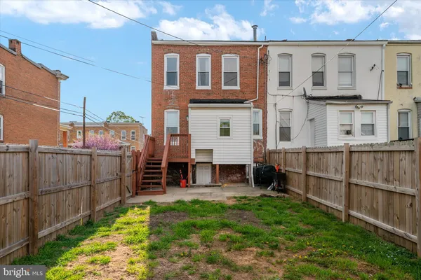 a view of a house with wooden fence