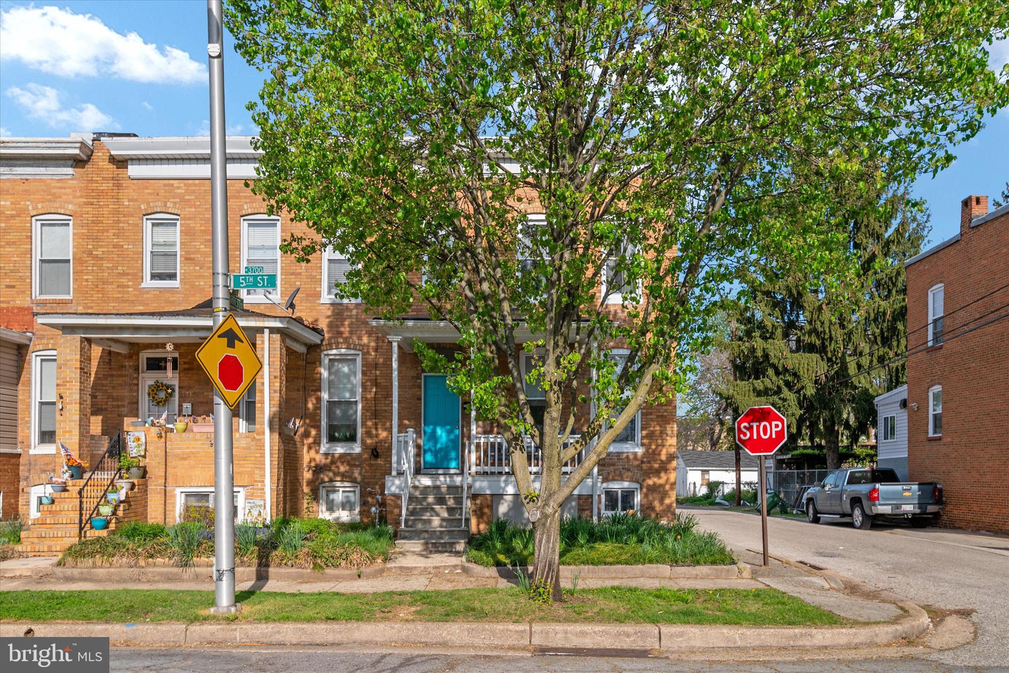 3714 5th Street Baltimore, MD 21225 - Photo 34 of 35 a street sign on a sidewalk next to a road