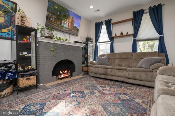 a living room with furniture and a fireplace