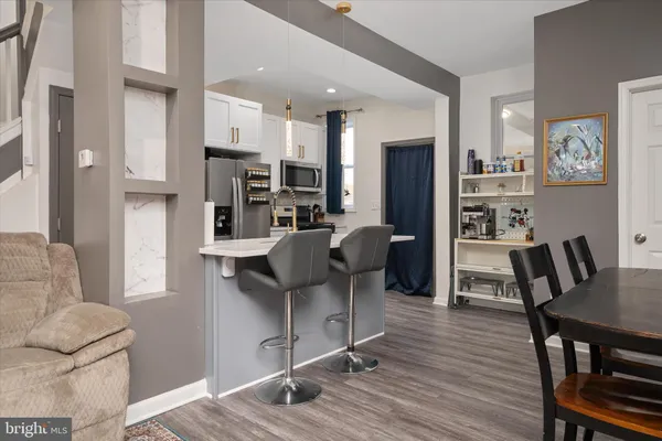 a view of a dining room with furniture and wooden floor