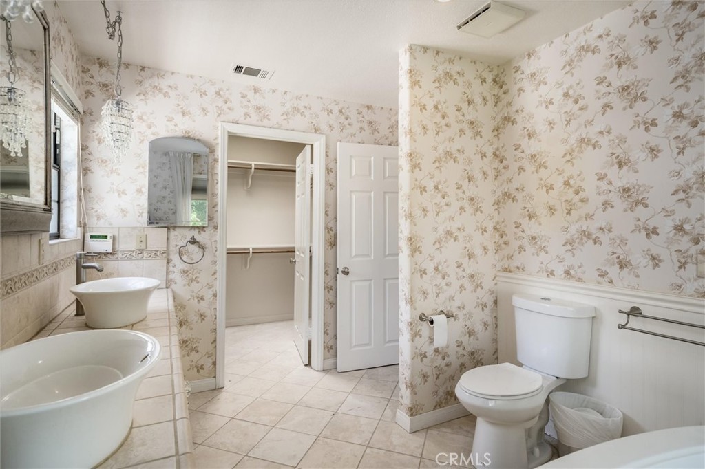 34150 Stowe Road Winchester, CA 92545 - Photo 31 of 80 a bathroom with a toilet sink and mirror