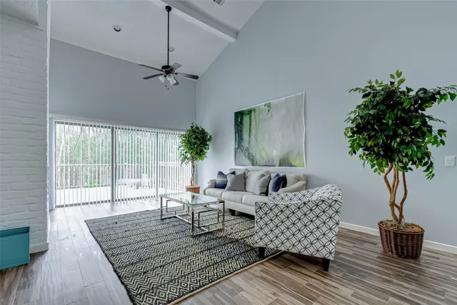 a living room with furniture and a potted plant