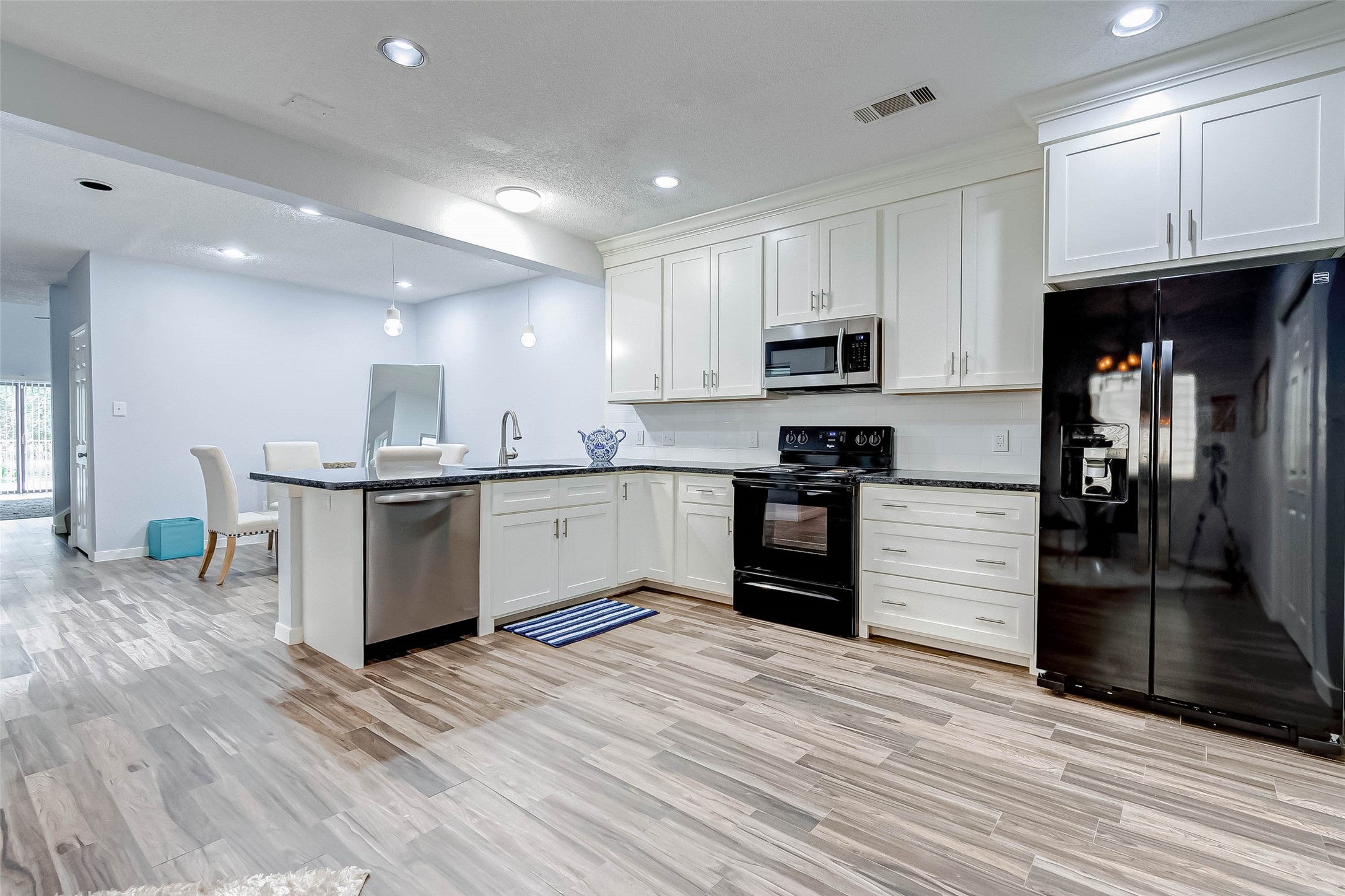 395 Rancho Bauer Drive Houston, TX 77079 - Photo 22 of 50 a kitchen with stainless steel appliances kitchen island granite countertop a refrigerator and a stove top oven