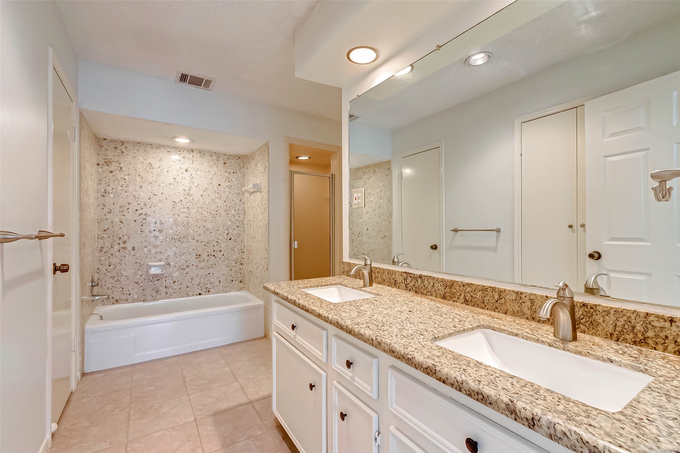 395 Rancho Bauer Drive Houston, TX 77079 - Photo 41 of 50 a bathroom with a granite countertop double vanity sink a mirror and a bathtub