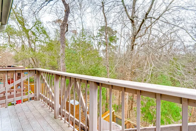 a view of balcony with wooden floor and fence