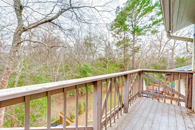 a view of balcony with wooden floor and fence
