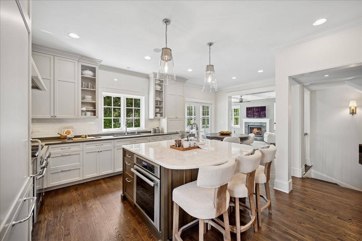 519 Cedar Street Winnetka, IL 60093 - Photo 11 of 36 a large kitchen with kitchen island a sink table and chairs