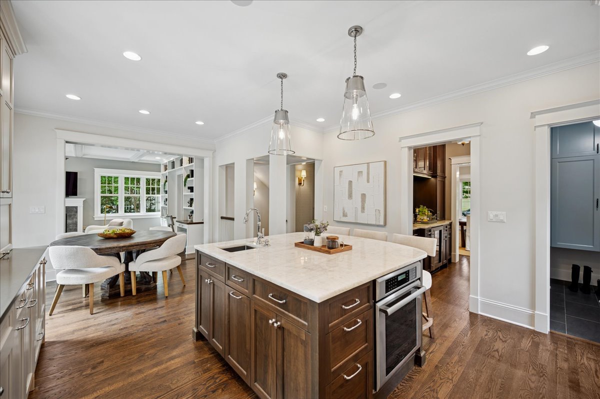 519 Cedar Street Winnetka, IL 60093 - Photo 12 of 36 a open kitchen with stainless steel appliances granite countertop a sink dishwasher and a dining table with wooden floor