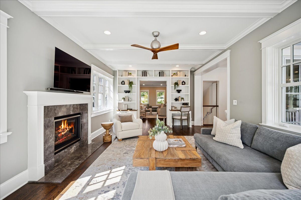 519 Cedar Street Winnetka, IL 60093 - Photo 15 of 36 a living room with furniture a fireplace and a flat screen tv