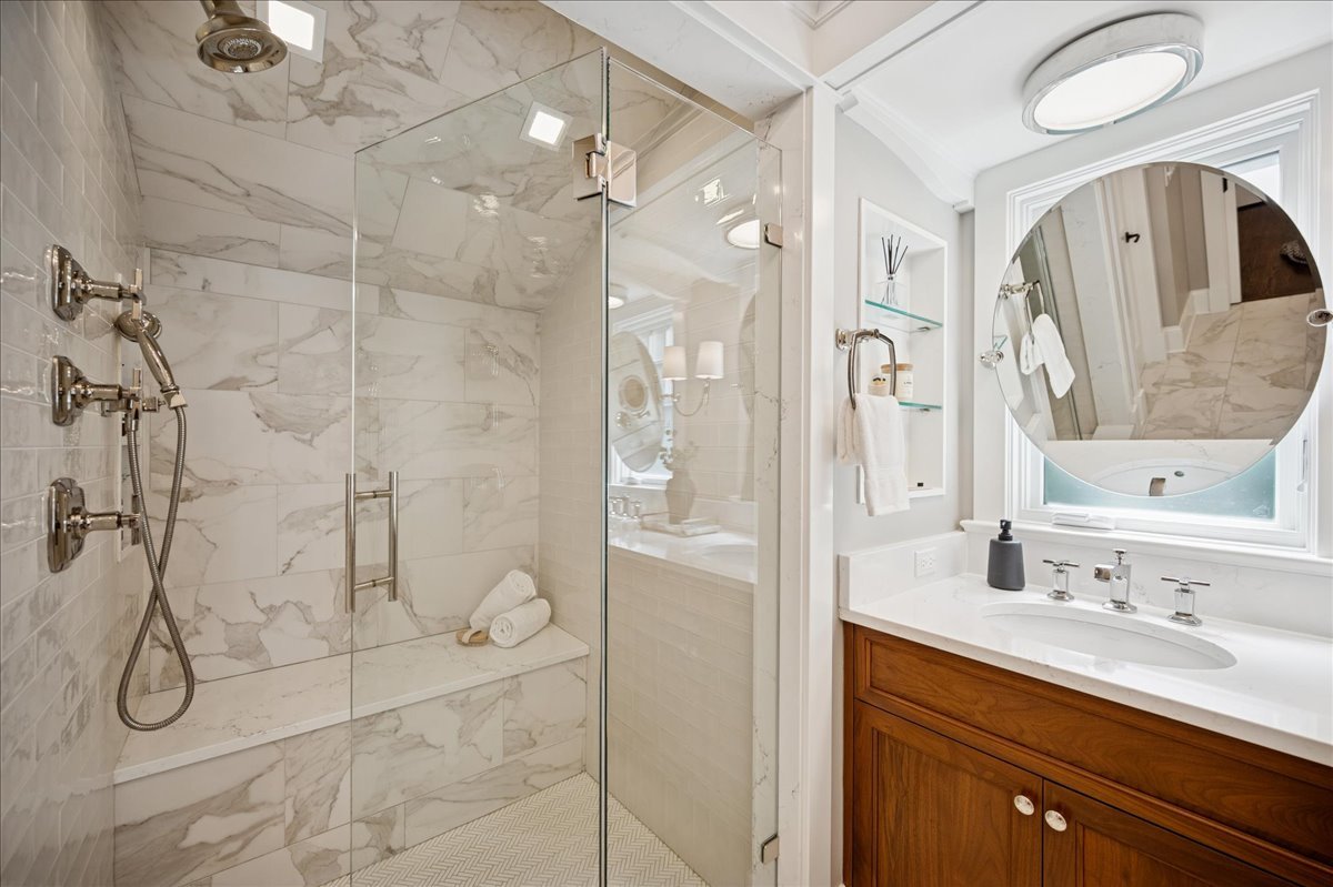 519 Cedar Street Winnetka, IL 60093 - Photo 20 of 36 a bathroom with a granite countertop shower sink and mirror
